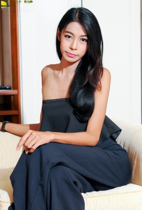 Shemale beauty Wan strips her elegant outfit & poses naked in a solo
